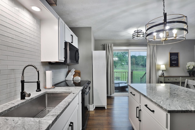 4634 State Route 61, Sunbury, OH 43074 - kitchen with black appliances, decorative backsplash, dark wood finished floors, light stone countertops, and white cabinets