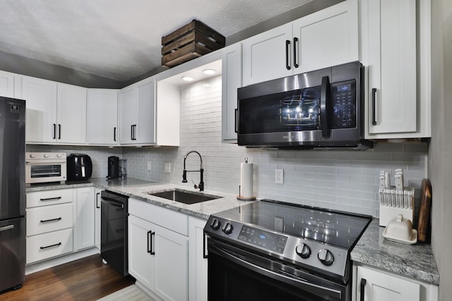 4634 State Route 61, Sunbury, OH 43074 - kitchen featuring black appliances, light stone countertops, decorative backsplash, and white cabinets
