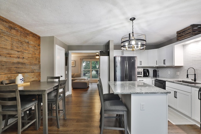 4634 State Route 61, Sunbury, OH 43074 - kitchen with freestanding refrigerator, a chandelier, a center island, light stone countertops, and tasteful backsplash