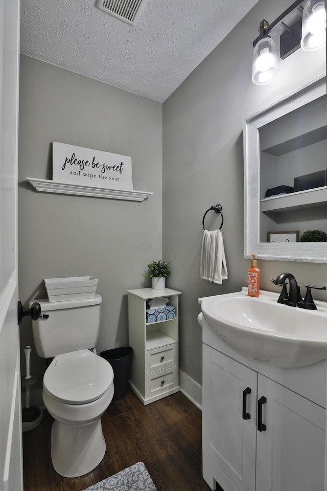 4634 State Route 61, Sunbury, OH 43074 - half bathroom with wood finished floors, vanity, and a textured ceiling
