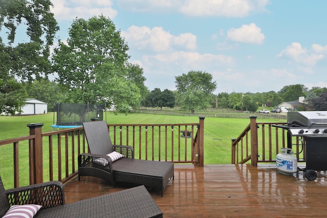 4634 State Route 61, Sunbury, OH 43074 - wooden deck featuring a trampoline, grilling area, a fenced backyard, and a rural view