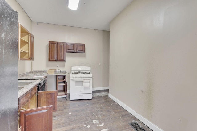 749-751 E Main St Unit 749, Columbus, OH 43205 - kitchen with white gas stove, open shelves, light wood-type flooring, and brown cabinetry