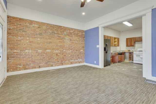749-751 E Main St Unit 749, Columbus, OH 43205 - unfurnished living room with a ceiling fan, light carpet, brick wall, and recessed lighting