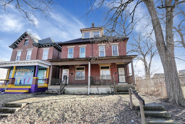 749-751 E Main St Unit 749, Columbus, OH 43205 - view of front of property with brick siding, a porch, and a chimney