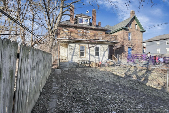 749-751 E Main St Unit 749, Columbus, OH 43205 - back of house featuring a fenced backyard, a chimney, entry steps, and brick siding