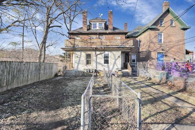 749-751 E Main St Unit 749, Columbus, OH 43205 - rear view of property with a balcony, a chimney, a fenced backyard, and a gate
