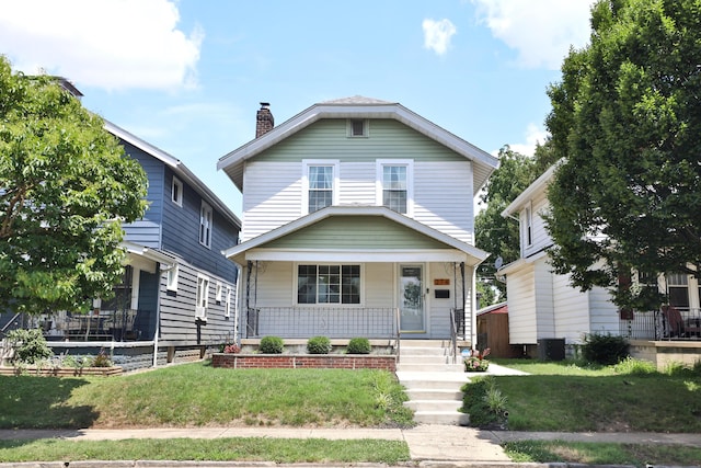 274 E Jenkins Ave, Columbus, OH 43207 - view of front of house featuring a porch, a front yard, and a chimney