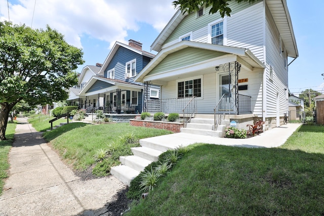 274 E Jenkins Ave, Columbus, OH 43207 - view of front of property featuring a porch, a front lawn, and a chimney