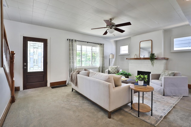 274 E Jenkins Ave, Columbus, OH 43207 - living room with light colored carpet, a fireplace, and a ceiling fan