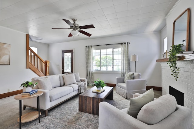 274 E Jenkins Ave, Columbus, OH 43207 - living area featuring stairway, ceiling fan, a brick fireplace, and ornamental molding