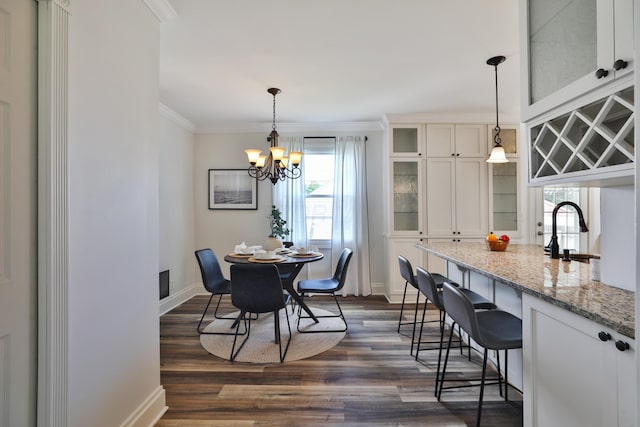 274 E Jenkins Ave, Columbus, OH 43207 - dining room with dark wood-type flooring, a chandelier, and ornamental molding