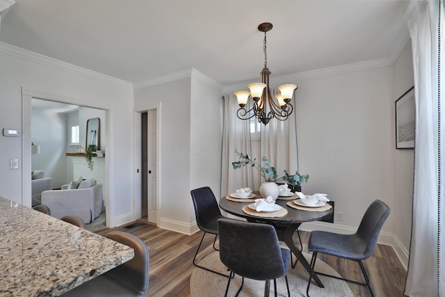 274 E Jenkins Ave, Columbus, OH 43207 - dining room featuring a chandelier, dark wood finished floors, and ornamental molding