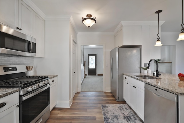 274 E Jenkins Ave, Columbus, OH 43207 - kitchen with appliances with stainless steel finishes, dark wood-type flooring, light stone counters, decorative backsplash, and crown molding