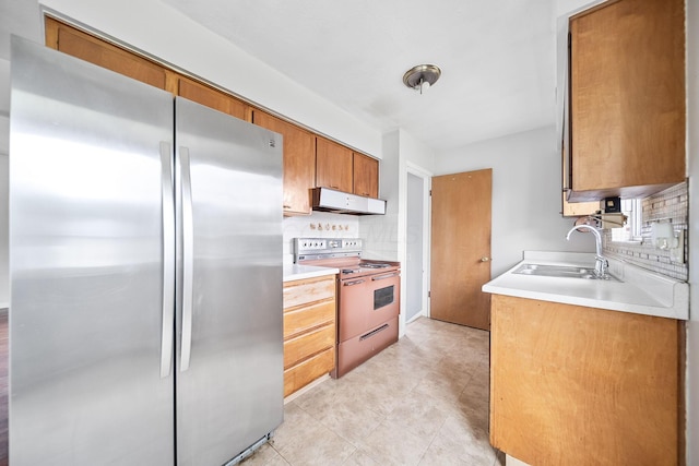 1799 Ormond Ave, Columbus, OH 43224 - kitchen with freestanding refrigerator, electric range, under cabinet range hood, backsplash, and light countertops