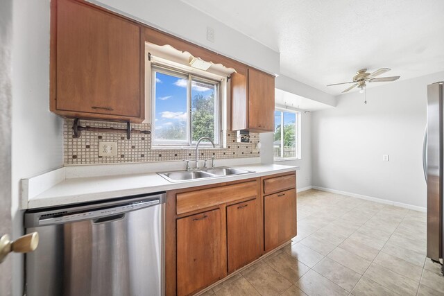 1799 Ormond Ave, Columbus, OH 43224 - kitchen with stainless steel appliances, backsplash, light countertops, a ceiling fan, and brown cabinetry