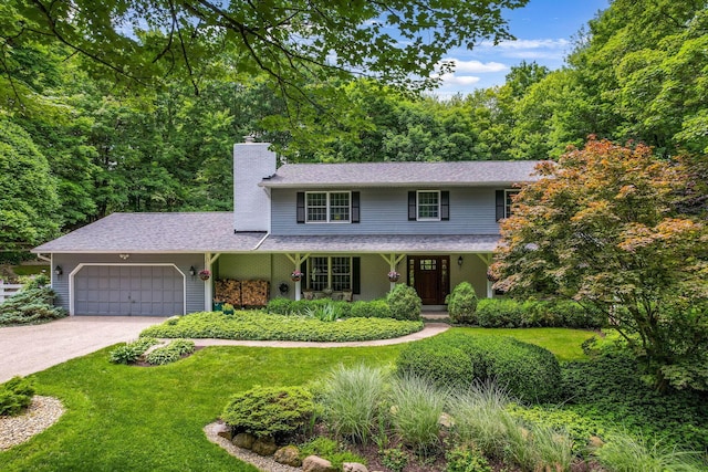2211 Welsh Hills Rd NE, Granville, OH 43023 - traditional-style home featuring a chimney, a garage, driveway, a front yard, and covered porch