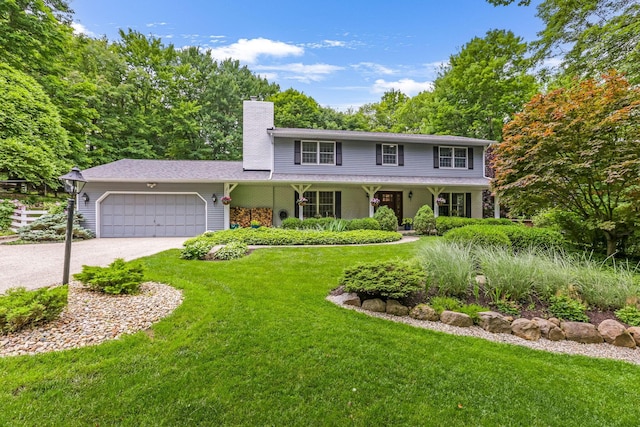 2211 Welsh Hills Rd NE, Granville, OH 43023 - view of front facade featuring a garage, a front lawn, a chimney, driveway, and covered porch