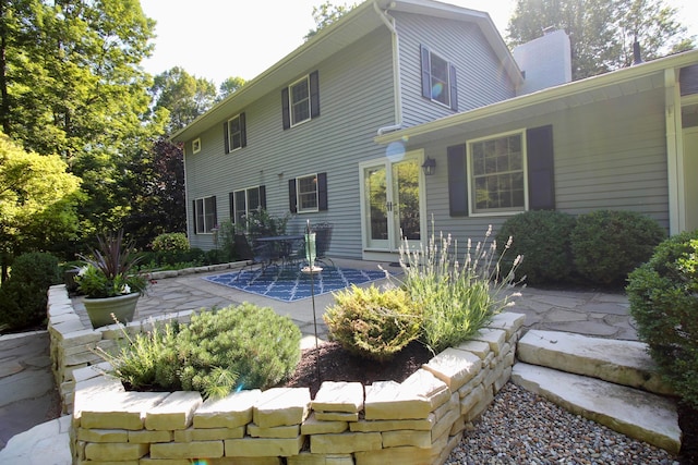 2211 Welsh Hills Rd NE, Granville, OH 43023 - back of house featuring french doors, a patio, and a chimney