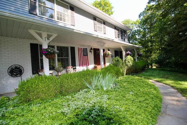 2211 Welsh Hills Rd NE, Granville, OH 43023 - view of front of home featuring brick siding, a porch, and a front yard