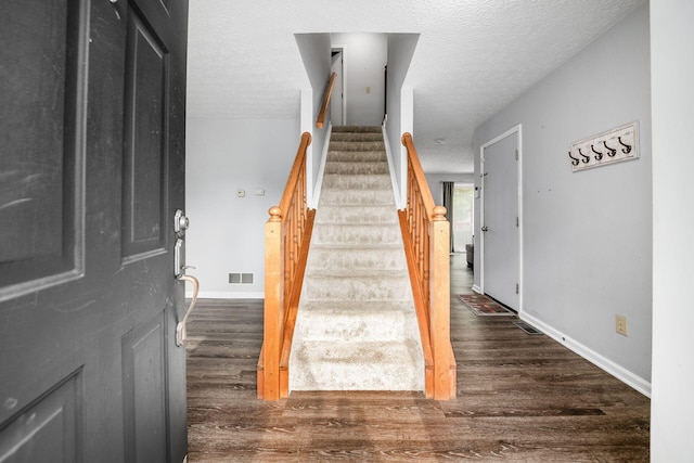 1191 Wexford Green Blvd, Columbus, OH 43228 - staircase featuring wood finished floors and a textured ceiling