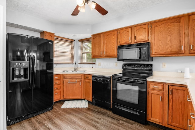 1191 Wexford Green Blvd, Columbus, OH 43228 - kitchen featuring black appliances, brown cabinets, ceiling fan, dark wood-style flooring, and a textured ceiling