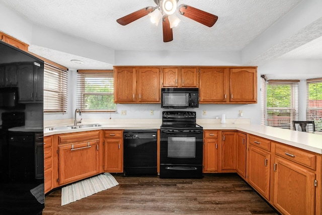1191 Wexford Green Blvd, Columbus, OH 43228 - kitchen with black appliances, light countertops, healthy amount of natural light, dark wood finished floors, and a textured ceiling
