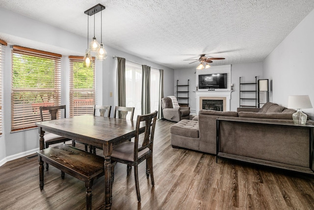 1191 Wexford Green Blvd, Columbus, OH 43228 - dining room with a ceiling fan, dark wood finished floors, a textured ceiling, and a glass covered fireplace