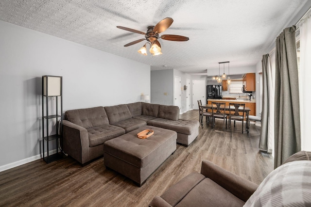 1191 Wexford Green Blvd, Columbus, OH 43228 - living room with wood finished floors, a ceiling fan, and a textured ceiling