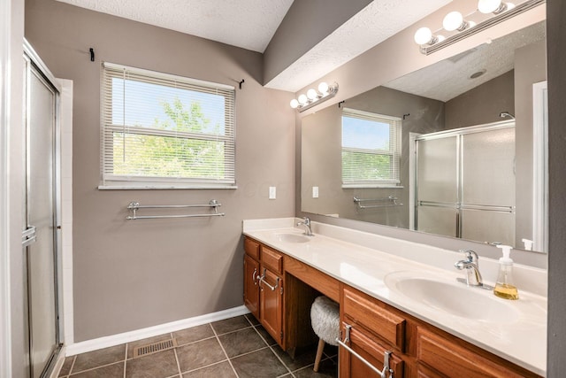 1191 Wexford Green Blvd, Columbus, OH 43228 - bathroom featuring a shower stall, double vanity, tile patterned floors, and a textured ceiling