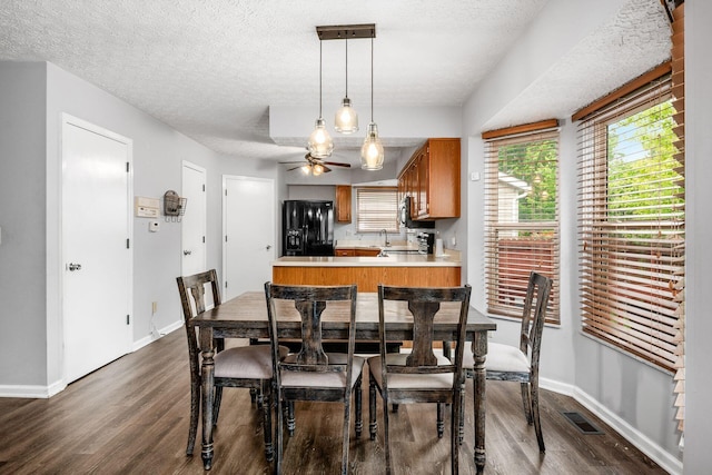 1191 Wexford Green Blvd, Columbus, OH 43228 - dining area featuring dark wood-style floors, plenty of natural light, a ceiling fan, and a textured ceiling