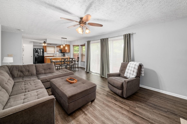 1191 Wexford Green Blvd, Columbus, OH 43228 - living room with a ceiling fan, dark wood-type flooring, and a textured ceiling