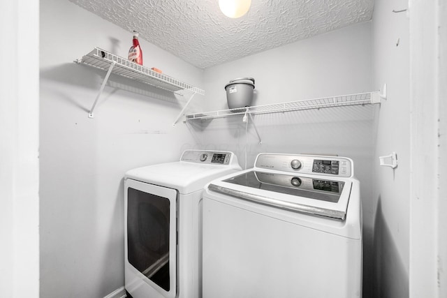 1191 Wexford Green Blvd, Columbus, OH 43228 - laundry area with washing machine and clothes dryer and a textured ceiling