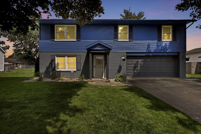 1588 Constitution Dr, Newark, OH 43055 - view of front of home with brick siding, a garage, and driveway
