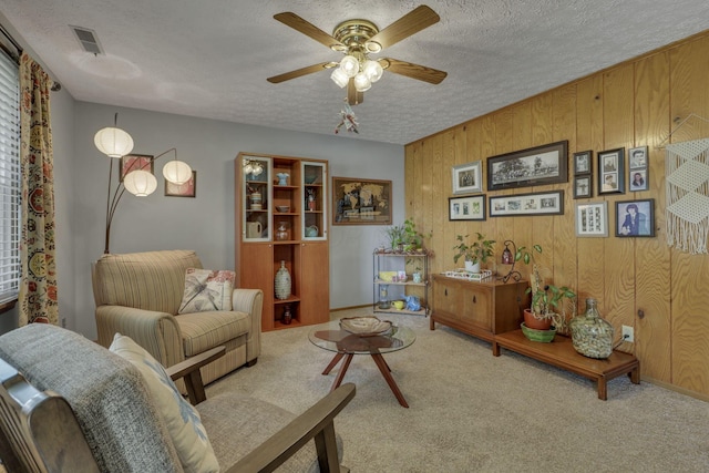1588 Constitution Dr, Newark, OH 43055 - carpeted living room featuring a ceiling fan, a textured ceiling, and wooden walls