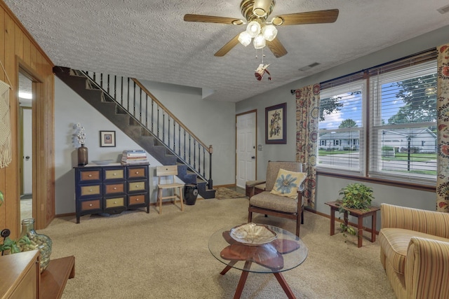 1588 Constitution Dr, Newark, OH 43055 - living room featuring a textured ceiling, carpet flooring, stairway, and a ceiling fan