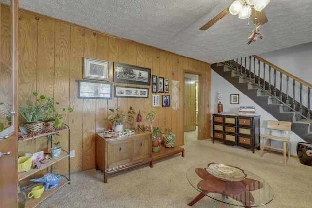1588 Constitution Dr, Newark, OH 43055 - carpeted living area featuring a ceiling fan, stairway, a textured ceiling, and wooden walls