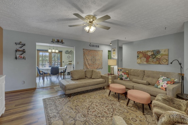 1588 Constitution Dr, Newark, OH 43055 - living room with wood finished floors, ceiling fan, a textured ceiling, and a chandelier