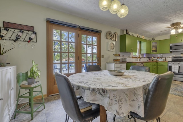 1588 Constitution Dr, Newark, OH 43055 - dining space featuring a textured ceiling, a chandelier, a ceiling fan, and light tile patterned floors