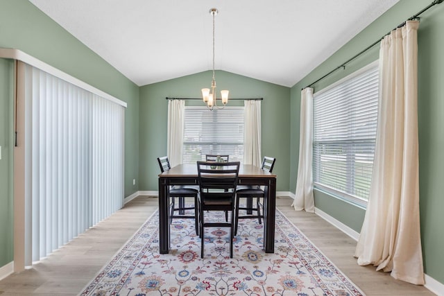 6452 Rockhold Dr, Westerville, OH 43081 - dining area featuring a chandelier, vaulted ceiling, and wood finished floors