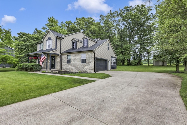 173 Zackary Dr, Granville, OH 43023 - view of front of home with stone siding, concrete driveway, a front lawn, and roof with shingles