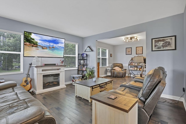173 Zackary Dr, Granville, OH 43023 - living area with dark wood-type flooring, a glass covered fireplace, and a chandelier