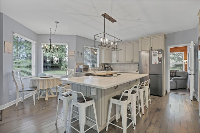 173 Zackary Dr, Granville, OH 43023 - kitchen featuring freestanding refrigerator, a chandelier, light countertops, and wood-type flooring