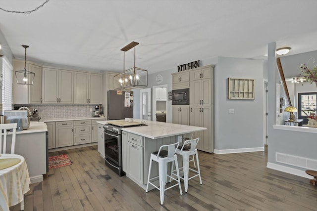 173 Zackary Dr, Granville, OH 43023 - kitchen featuring electric range, refrigerator, black microwave, backsplash, and wood-type flooring
