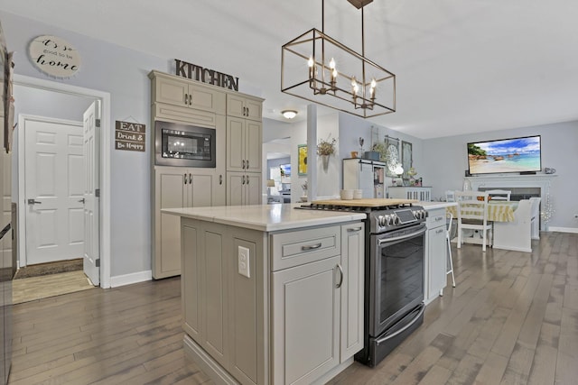 173 Zackary Dr, Granville, OH 43023 - kitchen with appliances with stainless steel finishes, dark wood-type flooring, light countertops, a chandelier, and a center island