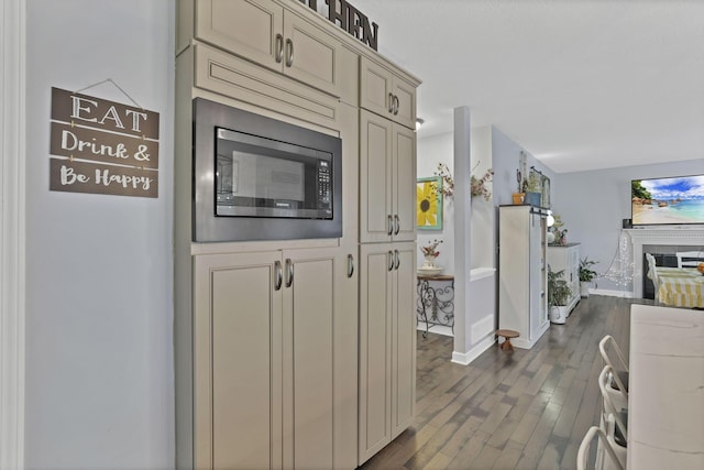 173 Zackary Dr, Granville, OH 43023 - kitchen with built in microwave, dark wood finished floors, open floor plan, and cream cabinets