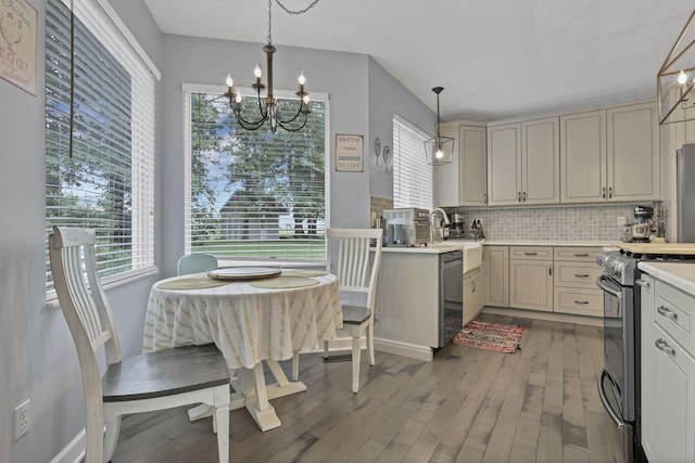173 Zackary Dr, Granville, OH 43023 - kitchen featuring stainless steel gas range, dishwasher, dark wood-type flooring, and a chandelier