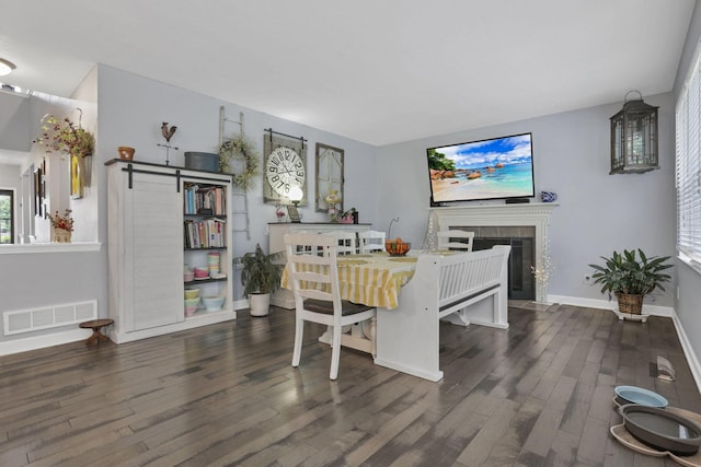 173 Zackary Dr, Granville, OH 43023 - dining space with wood finished floors, a fireplace, and a barn door