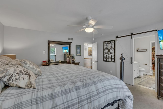 173 Zackary Dr, Granville, OH 43023 - bedroom with light colored carpet, a barn door, and a ceiling fan