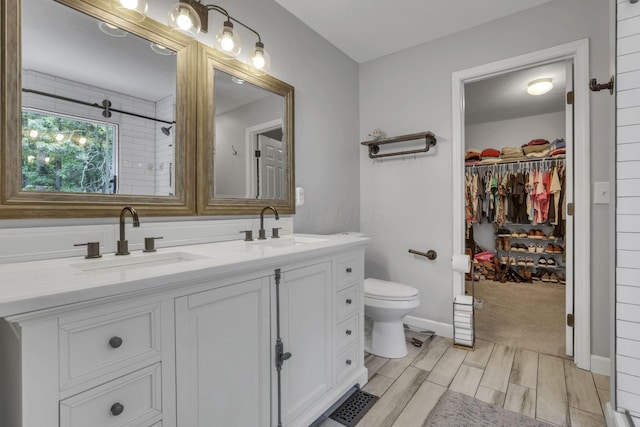 173 Zackary Dr, Granville, OH 43023 - full bath featuring double vanity, a walk in closet, wood tiled floors, and a shower