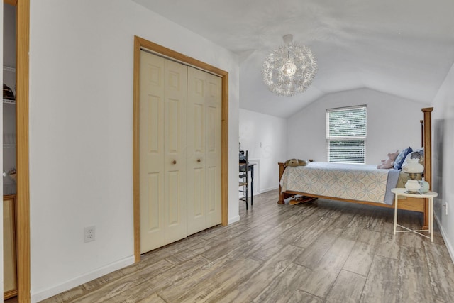 173 Zackary Dr, Granville, OH 43023 - bedroom with lofted ceiling, wood finished floors, a closet, and a chandelier